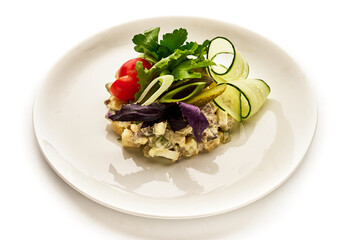 A plate of food with a variety of vegetables including cucumbers, tomatoes