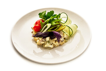 A plate of food with a variety of vegetables including cucumbers, tomatoes