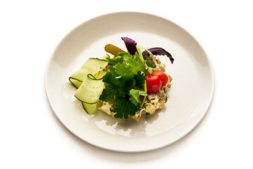 A plate of food with a variety of vegetables including cucumbers, tomatoes