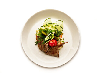 A plate of food with meat and vegetables on it