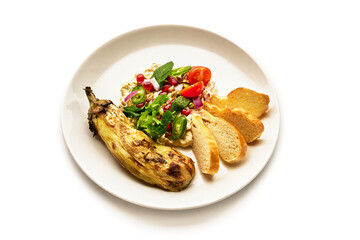 A plate of food with a vegetable and a salad