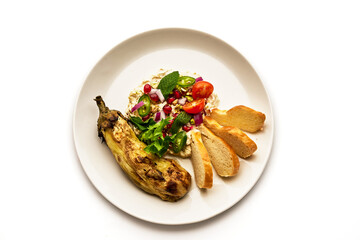 A plate of food with a vegetable and a salad