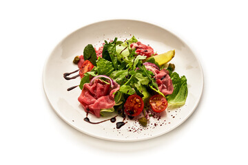 A plate of food with a variety of vegetables and meat