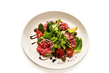 A plate of food with a variety of vegetables and meat