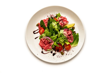 A plate of food with a variety of vegetables and meat