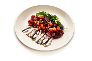 A plate of food with a variety of vegetables and a piece of meat. The plate is white and the food is colorful