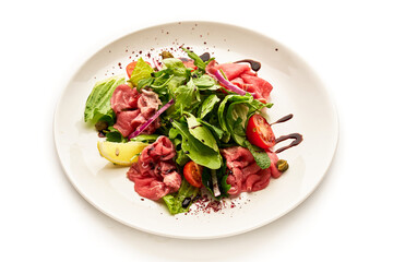 A plate of food with a salad on it