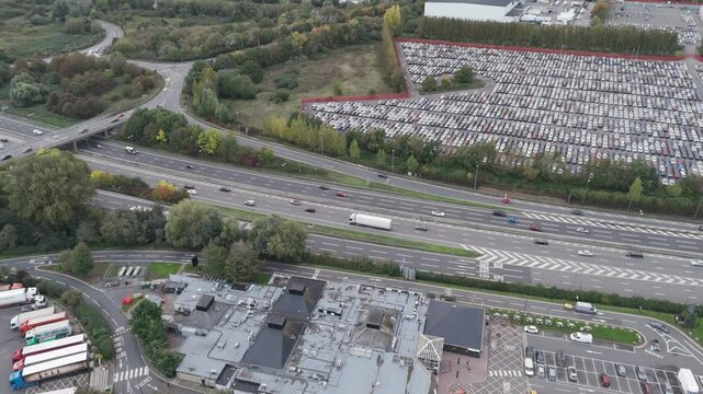 Aerial view of M5 motorway with flowing traffic near Royal Portbury Dock, showing transport infrastructure and industrial landscape with parked vehicles