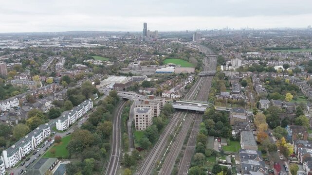 Expansive aerial view of London skyline and central railway line running from Reading to London, showing the dense infrastructure and urban sprawl around Ealing