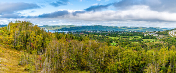 A view over treetops towards Corner Brook in Newfoundland, Canada in the fall