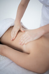 Fototapeta premium Close-up of masseur's hands on back. close-up masseur hands doing back massage in spa salon. Beauty treatment concept.