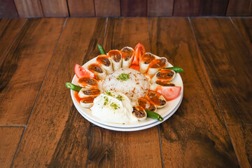 Turkish Meat Beyti Kebab with rice and yogurt served in plate isolated on wooden table side view of turkish fast food