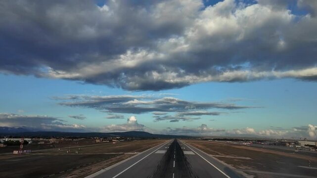 Pilot&rsquo;s FPV approach tom land at Palma de Mallorca&rsquo;s airport runway with a blue sky covered with some white and grey stratus clouds recorded with the late afternoon light. 4K 60FPS