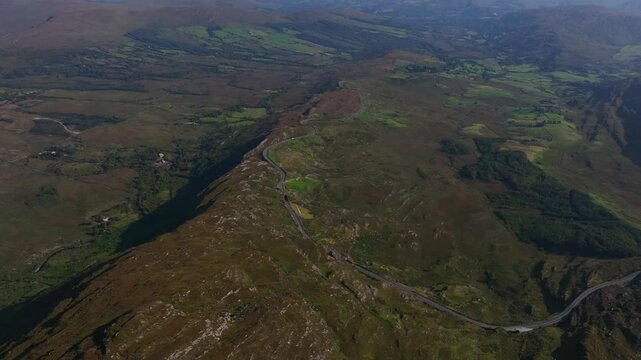 Caha Pass, County Cork, Ireland, September 2024. Drone stunning overview from high angle perspective of winding mountain road crossing the border with County Kerry.