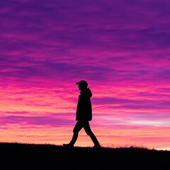 Obraz premium Silhouette of a person walking against a vibrant purple and pink sunset sky, capturing the essence of adventure and solitude. Job ID: 53dc8b44-c5a3-44f3-9b89-206686b4d5d9