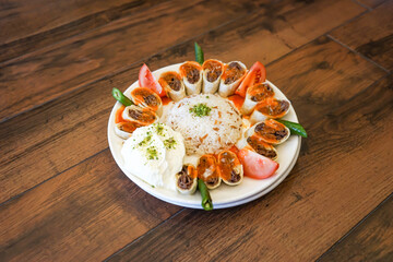 Turkish Meat Beyti Kebab with rice and yogurt served in plate isolated on wooden table closeup side view of turkish fast food