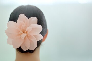 Naklejka premium Elegant chignon adorned with a soft pink flower decor