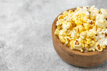 Salty popcorn on bright color background. Cinema and entertainment concept. Movie night with popcorn. Delicious appetizer, snack.Space for text, copy space. Banner