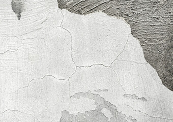 texture of white wall with fallen off piece of dark concrete wall texture.