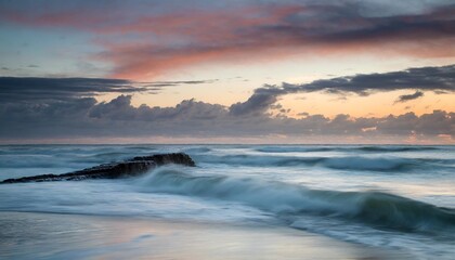 Coastal Landscape at Sunrise with Rolling Waves and Vibrant Sky Hues
