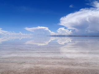 salar de Uyuni, Bolivia. Scenic salt flat flooded with water in South America. Sur Lipez travel destination in sunlight