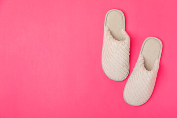 Soft slippers on a bright colored background, close-up. House slippers. Comfortable shoes for home. Foot care concept. Home comfort. Space for text. Copy space.