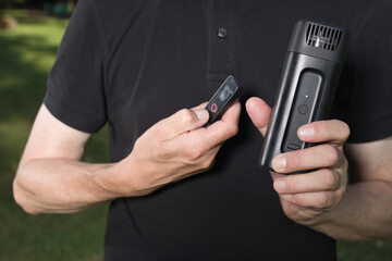 Older man uses two types of smoke machine generators on outdoor location
