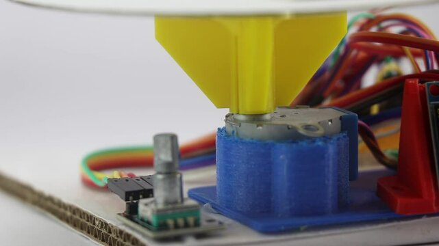 Rotary encoder and stepper motor view that is controlled by micro controller on the background. 3d printed parts on a stepper motor