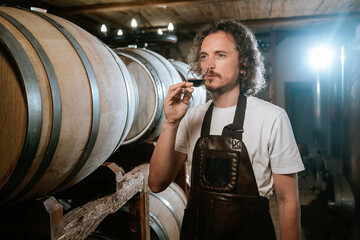 Winemaker Smelling Aroma of Red Wine in Cellar