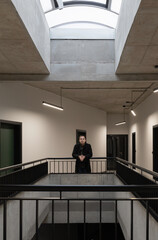 man in black jacket in modern corridor