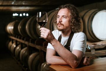 Winemaker Inspecting Red Wine in Cellar