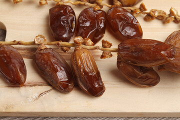 dried dates on wooden background