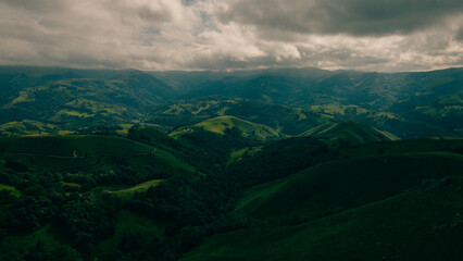 A breathtaking view of lush green hills unfolds, capturing the serenity of the French Pyrenees on the Camino de Santiago.