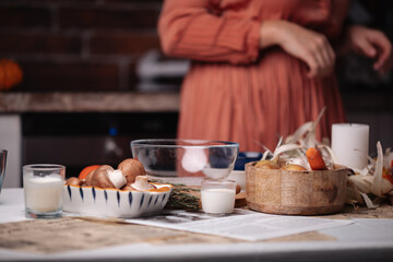 kitchen, a woman cooks, food and plates on the table
