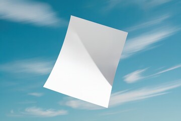 Blank white poster floating against clear blue sky with soft clouds and sunlight highlights creating a serene and minimalist aesthetic
