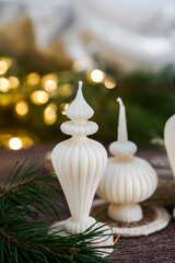 Ribbed Eco-friendly candles made from soy and olive oil wax, surrounded by pine branches and festive lights.