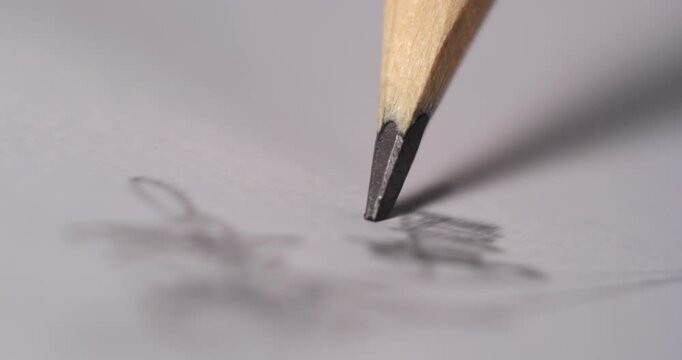 Close-up of pencil tip creating sketch on paper, showcasing delicate textures and intricate details of drawing process with soft lighting