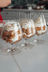 A beautiful dessert, tiramisu in a glass, several guests.