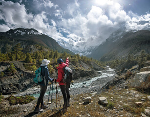 Women tourists with backpacks discuss hiking route against background of beautiful mountain landscape