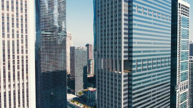 Close-up view of modern Chicago skyscrapers. Detailed close-up of high-rise buildings in downtown Chicago, showcasing the architectural designs and glass facades on a sunny day.