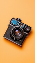 Fototapeta premium Vintage Camera on Vibrant Orange Background Showcasing Classic Photography Equipment and Retro Style