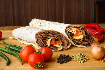 Beef Doner Wraps Shawarma isolated on wooden table side view of arabic and turkish street food