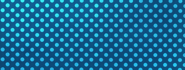 Navy blue and background from wrapping paper with pattern of turquoise polka dot closeup.