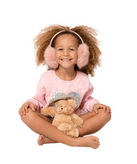 Little child girl wearing earmuffs is hugging teddy bear isolated over transparent background. PNG transparent.