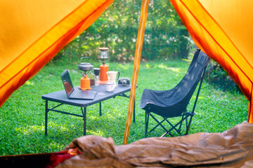 Looking out from the inside of the tent to Resting equipment for setting up a camping tent In the...
