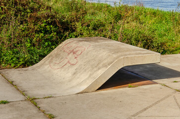 Zutphen, The Netherlands, September 28, 2024: creatively shaped concrete bench by the riverside