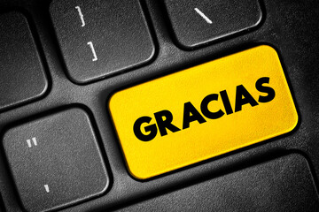 Gracias (thank you in spanish) text button on keyboard, concept background