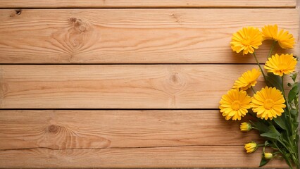 A bouquet of yellow daisies rests on a wooden surface, with a textured and weathered appearance.