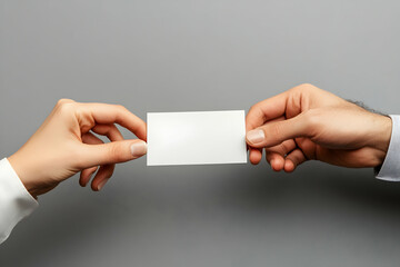 Two hands exchanging a blank white card against a gray background.