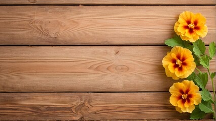 Three yellow flowers with red centers are arranged diagonally on a wooden background.